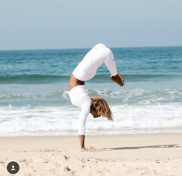 Woman doing yoga on the beach